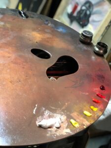 Painting tools and palette in the studio of contemporary artist Virginie Martin Blaise