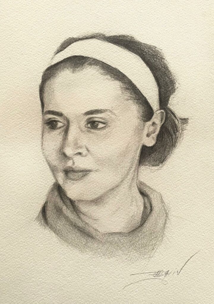 Pencil portrait of a young woman wearing a headband, drawn on paper with soft shading and a calm expression.